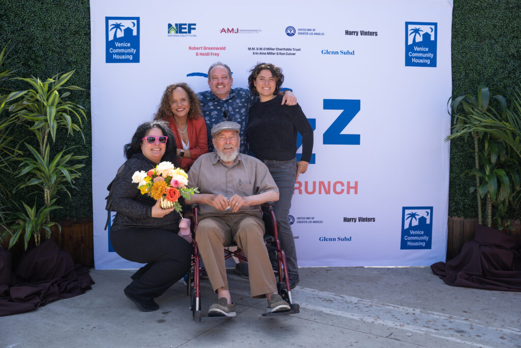A group in front of step-and-repeat backdrop at Jazz Brunch